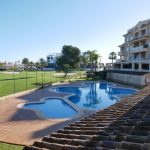 EXCM-OlivaNova2. A 67 golf apartment with parking and pool for sale in Oliva Valencia Spain